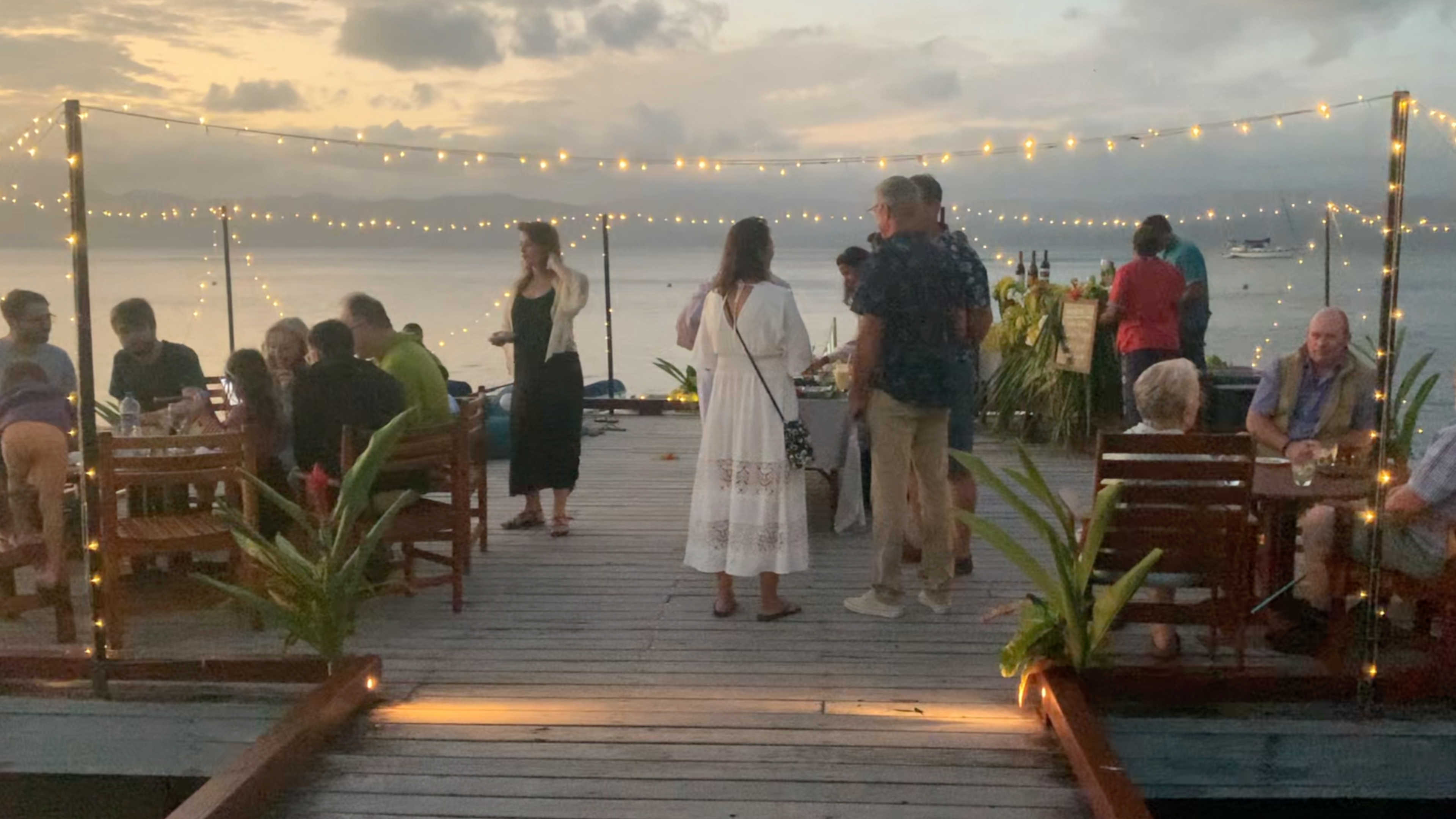 On the pier for the resort's guest sundowner happy hour with cocktails, the bula band and hors d'ouevres