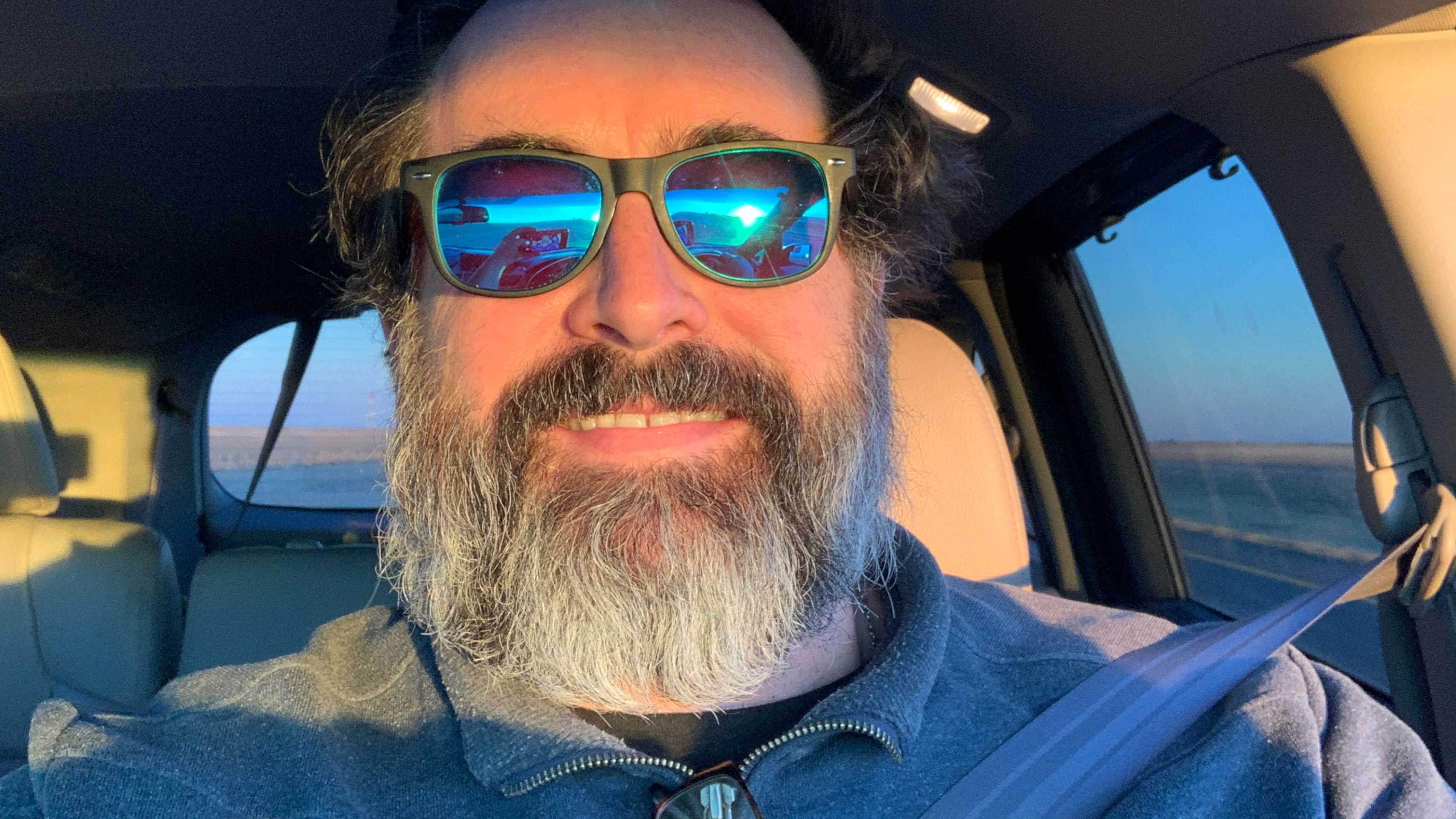 Selfie inside the van with sunglasses on, while on the road