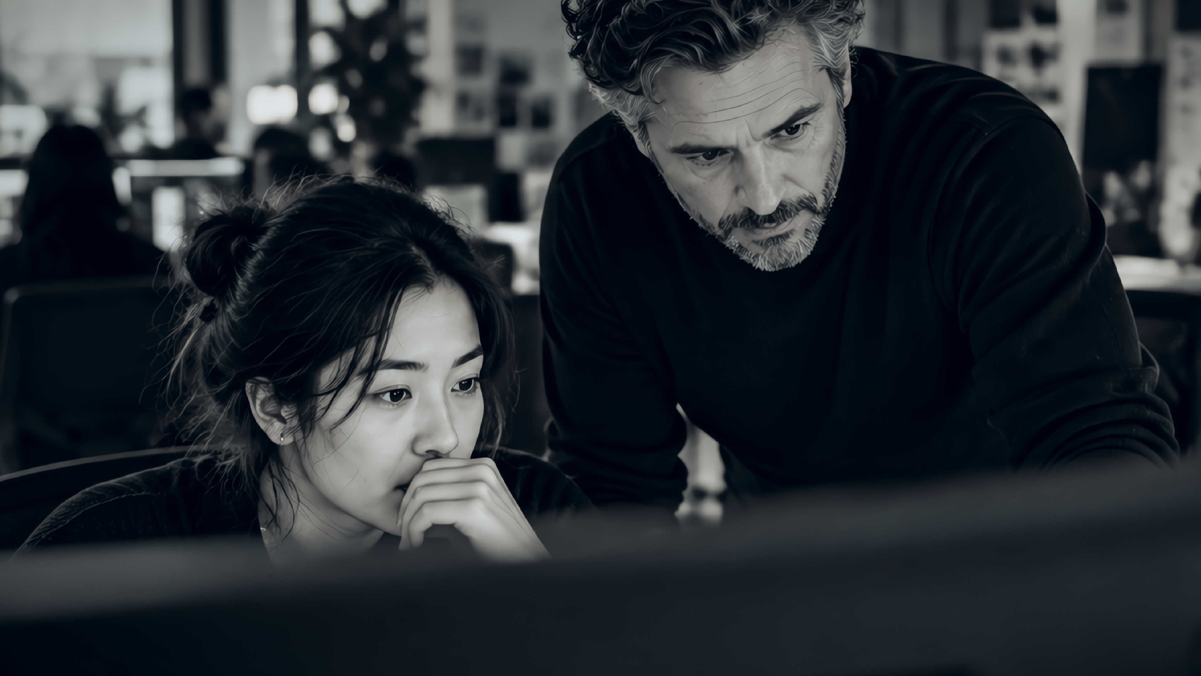 Editorial photo of a man and woman looking at the computer screen.